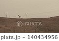 Oil pumpjack extracting petroleum in rural field 140434956