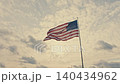 American flag waving in the wind against a cloudy sky 140434962