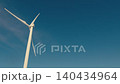 Wind turbine propeller blades spinning against blue sky 140434964