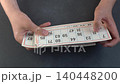 Hands Holding Vintage Lotto Cards with Numbers. Old Bingo game 140448200