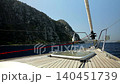 A view from the bottom of a wooden deck of a sailing vessel sailing along the beautiful rocky shore of the bay 140451739