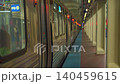 Chicago subway train standing at an underground platform with glowing lights and long perspective view. Urban public transportation scene showing rail cars, columns, and station architecture. 140459615