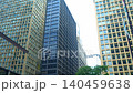 Glass and steel office buildings rise in downtown Chicago forming a dense modern business district. The urban scene emphasizes architecture, corporate environment, and city development. 140459638