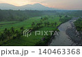 Terraced Rice Fields at Sunrise in Indonesia. Beautiful panoramic view of terraced rice fields surrounded by lush tropical greenery and palm trees 140463368