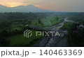 Terraced Rice Fields at Sunrise in Indonesia. Beautiful panoramic view of terraced rice fields surrounded by lush tropical greenery and palm trees 140463369