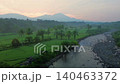 Terraced Rice Fields at Sunrise in Indonesia. Beautiful panoramic view of terraced rice fields surrounded by lush tropical greenery and palm trees 140463372