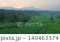 Terraced Rice Fields at Sunrise in Indonesia. Beautiful panoramic view of terraced rice fields surrounded by lush tropical greenery and palm trees 140463374
