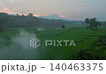 Terraced Rice Fields at Sunrise in Indonesia. Beautiful panoramic view of terraced rice fields surrounded by lush tropical greenery and palm trees 140463375