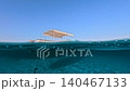Fishing Boat Anchored In Half Underwater View With Clear Blue Tropical Sea 140467133