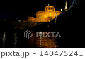 castel sant angelo illuminated at night over the tiber river 140475241