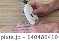 epilator whirring when removing hair from skin 140486410