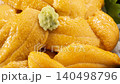 A luxurious seafood dish featuring fresh sea urchin from Hokkaido piled high in a glass bowl. 140498796