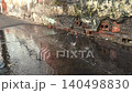 Wet Sidewalk Puddles and Rain Drops on Urban Street Pavement close up 140498830