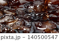 Slow motion closeup pouring cola with ice cubes and bubbles, soft drink top view 140500547