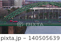 Telephoto clip as drone tracks sideways beside the Wearmouth Bridge in Sunderland as early morning traffic commutes to the city 140505639
