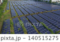 [Aerial view] Mega solar power plant adjacent to factory and logistics facility against a blue sky (image material for self-consumption, ESG investment, and SDGs) 140515275