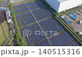 [Aerial view] Panoramic and receding views of a mega solar power plant adjacent to a baseball field and factory (image of land use, renewable energy, and SDGs) 140515316