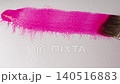 Close up of pink watercolour drawing paints on paper. Artist draws with a brush, liquid analog 140516883