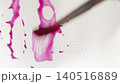 Close up of pink watercolour drawing paints on paper. Artist draws with a brush, liquid analog 140516889