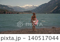 woman long hair in white swimsuit standing on shore Turquoise Azure Water 140517044