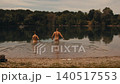 man and woman enter river, swim naked in nature alone, wild vacation camping 140517553