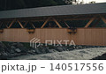 woman walks across wooden bridge fast narrow mountain river in Switzerland slow motion 140517556