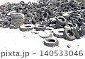 Footage of car tire disposal in winter: a pile of old rubber tires and wheels dumped in the snow, awaiting further recycling, processing, and waste management. High quality 4k footage 140533046