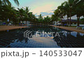 Watch as the dawn light changes over a hotel resort in Thailand. The pool reflects the sky while palm trees stand tall. This shows the start of a new day in a tropical setting. High quality 4k footage 140533047