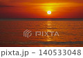 Orange sunset - the sun sets over the horizon at sunset evolve over the Andaman sea in Thailand. The sun changes colors as it sets reflecting light on water's surface. It captures the beauty timelapse 140533048