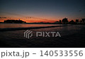 A sunset view of the Enoshima Bridge and the silhouette of Mount Fuji bathed in orange light, seen from Koshigoe Fishing Port. 140533556