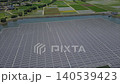 [Aerial video] Wide shot of a floating mega solar power plant on a reservoir and the surrounding rural landscape (Renewable energy, SDGs) 140539423
