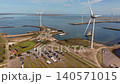 Aerial view of Neeltje Jans visitor center, tourist park with parking lot, and large wind turbines on an artificial island in Zeeland, Netherlands. 140571015