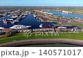 Aerial panoramic view of Vlissingen industrial harbor port with luxury superyachts, cargo ships, commercial docks, and seaside town infrastructure in Zeeland, Netherlands during spring season. 140571017