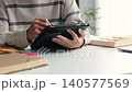 College student studying for exams with digital tablet at home. 140577569