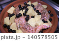 Raw seasoned chicken legs with potatoes and black olives simmering in a traditional moroccan tagine pot on a stove top, ready for cooking an authentic north african stew with aromatic spices 140578505