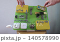Busy board is educational toy usually in form of board or panel with different everyday objects attached including locks buttons zippers shoelaces switches safe electrical outlets doors and more. 140578990