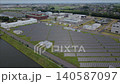 [Aerial video] Mega solar power plant and water treatment plant: A landscape of solar power generation and infrastructure facilities in the suburbs. 140587097