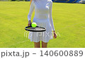 Young Woman Practicing Tennis Ball Juggling With Racket on Outdoor Clay Court, Female Athlete in White Sports Outfit Training Coordination and Ball Control During Sunny Day Match Practice, Handheld 140600889