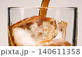 Slow motion closeup pouring cola with ice cubes and bubbles, soft drink texture 140611358