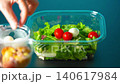 Prepare lunch chicken salad for work in plastic containers. Healthy food. Egg 140617984