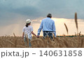agriculture. happy family farmer. father daughter walking hand through wheat field. working digital tablet. child dad sunset. father child holding hands wheat field sunset. little girl with any 140631858