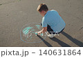 Clean planet Earth, boy child draws chalk asphalt, Kid child baby boy, Hopeful chalk artist, boy embracing Earth, outdoor creative session, green art initiative, child drawing with meaning, nature 140631864