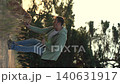 male dog handler walks with dog sunset, pet domestic pet sunset, sunset dog walking, evening nature outing, man with pet dog, happy, peaceful evening stroll, sunset walk with pet, leisure time outside 140631917