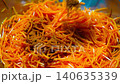 Preparing Fermented marinated carrot salad. Korean style Healthy food. Sprinkle the salad with red chili pepper  140635339