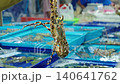 Fishmonger showing live spiny lobster to customers at seafood market. Fresh live seafood trade at a traditional wet market in Thailand 140641762