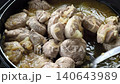 Pork and chopped onions are cooking together in a simple homemade broth 140643989