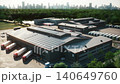 Modern Logistics Warehouse Complex with Solar Panels and Truck Loading Docks - Aerial View 140649760