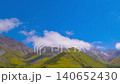 Zooming in time-lapse of green mountains with white clouds flowing above in Kyrgyzstan 140652430