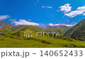 Time-lapse of clouds flowing above green mountains in Kyrgyzstan at sunny summer day. 140652433