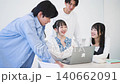 University students gathered around a computer 140662091